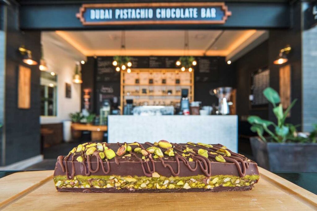 Dubai pistachio chocolate bar with layers of melted chocolate, roasted pistachios, and shredded Knafeh dough