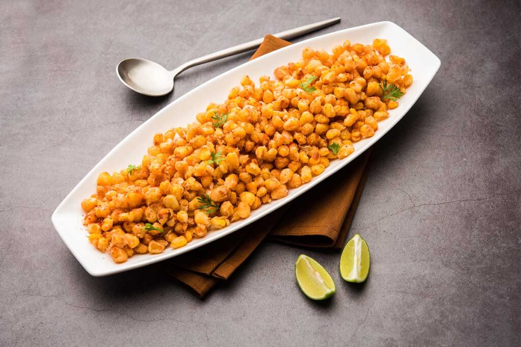 Freshly sautéed Southern fried corn in a skillet with butter and herbs.