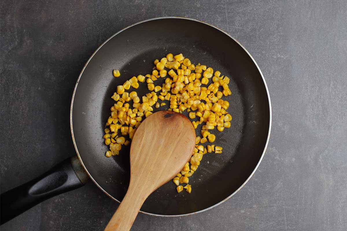 Healthy crispy fry corn in a skillet with herbs and seasoning