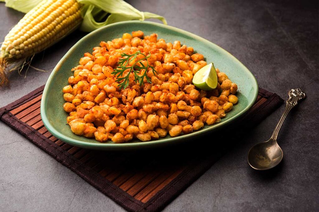 Freshly fried corn with butter in a skillet