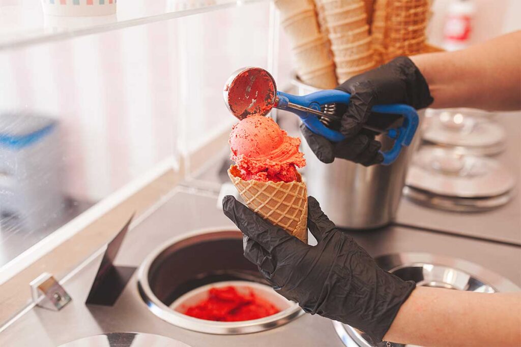 Making of creamy homemade strawberry ice cream with fresh strawberries