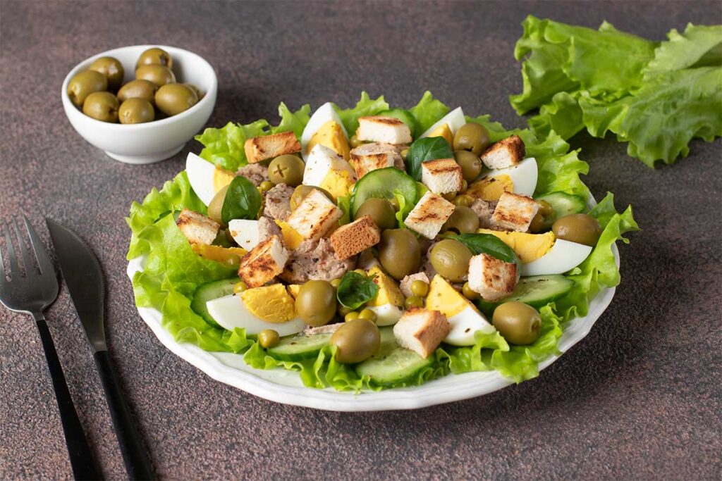 A bowl of vibrant Mediterranean olive salad made with olives, pickled vegetables, and olive oil.