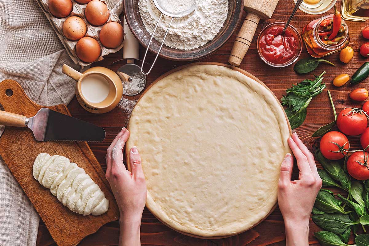 Regular pizza dough being prepared for cooking in an Ooni oven.