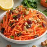 Bowl of carrot raisin salad with a creamy dressing